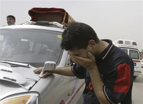 A man cries for his relative killed in clashes between Mahdi Army militia fighters and the Iraqi government forces backed by the US military in the Shiite stronghold of Sadr City, in Baghdad, Iraq, Wednesday, March 26, 2008. Karim Kadim, The Associated Press
