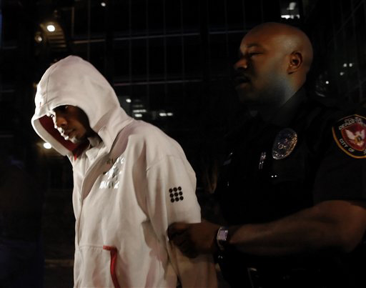 Lawrence Alvin Lovett Jr., 17, is escorted by Durham police officers out of the Durham Police Department in Durham, N.C., Thursday, March 13, 2008. Lovwtte, the second suspect charged with murdering University of North Carolina student body president Eve Sara D. Davis
