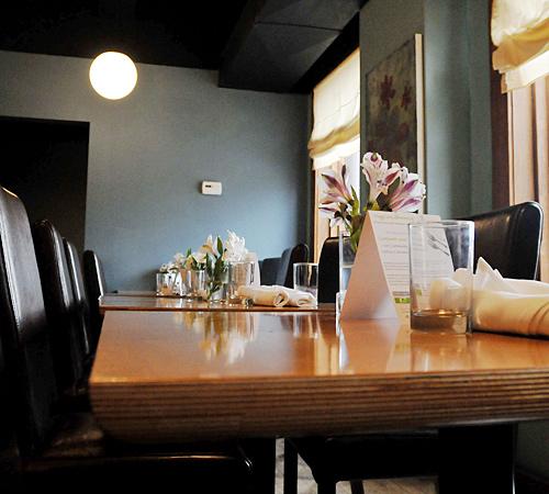 Tables sit arranged with silverware and flowers at Cafe Luna in Champaign. The restaurant will be moving to downtown Champaign, inside the former Illinois Central Railroad Station. Erica Magda
