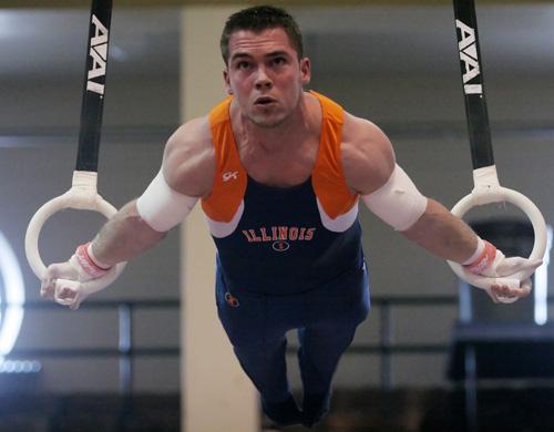 Illinois gymnast Jon Drollinger performs on the rings during the gymnastics meet at Huff Hall on Saturday. Drollinger received a 15.1 on the rings, helping the Illini to defeat Michigan. Erica Magda
