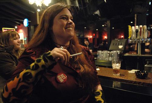 An Act Now button (purchased for $1) identifies Courtney Conk as an improvisational actress, allowing her to light up a cigarette at the Rock Nightclub on theater night in Maplewood, Minn., on Wednesday. Janet Hostetter, The Associated Press

