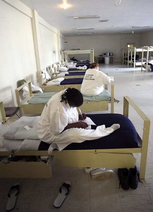 Inmates at Julia Tutwiler Prison for Women pass the time in the HIV ward in Wetumpka, Ala., on March 17. Alabama is the only state that bars prisoners with the AIDS virus from participating in work release programs. Jamie Martin, The Associated Press

