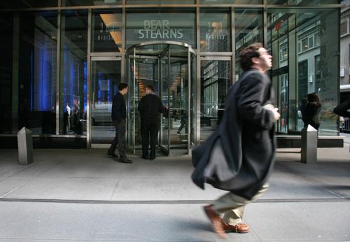 A businessman runs past Bear Stearns in New York on March 14. The bank recently collapsed after the government attempted to support it. The Associated Press
