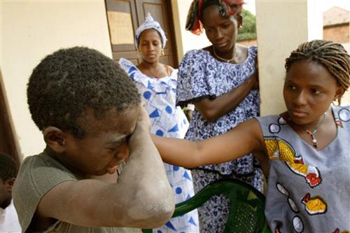 Coli, a former religious student who fled the Quranic teacher that forced him to beg on the streets of Dakar, Senegal, cries as female relatives arrive to meet him at a temporary shelter in Gabu, Guinea-Bissau, Monday, Dec. 17, 2007. The overwhelming majo Rebecca Blackwell, The Associated Press
