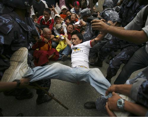 Police drag away protesters for detention as Tibetans demonstrate against China outside the Chinese Embassy in Katmandu, Nepal, on Tuesday. China has accused the Dalai Lama of plotting violent attacks. Saurabh Das, The Associated Press
