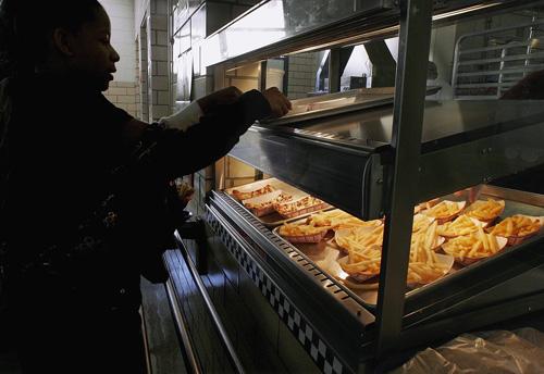Students eat the food served in the cafeteria during lunch at Washington Middle School in Springfield, Ill., on April 2. Illinois legislators are considering a ban on trans fats in foods served in school cafeterias and vending machines. Seth Perlman, The Associated Press
