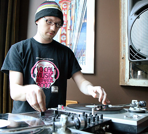 DJ Bozak of Champaign demonstrates how to scratch at Boltini Lounge in downtown Champaign on Monday. Erica Magda
