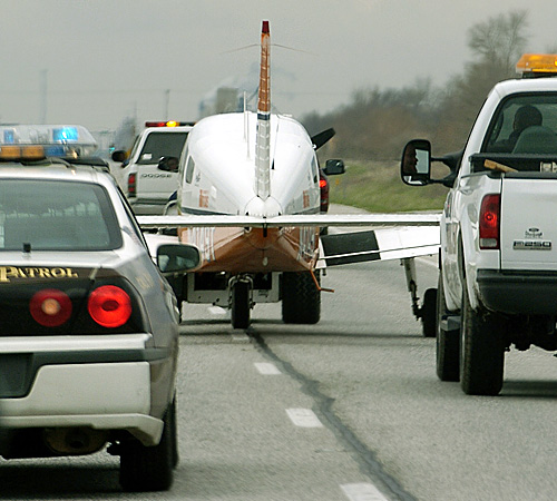A Champaign County Sheriff escorts a UI school of aviation plane after the pilot had to perform an emergency landing in a field near Savoy on Saturday. Erica Magda
