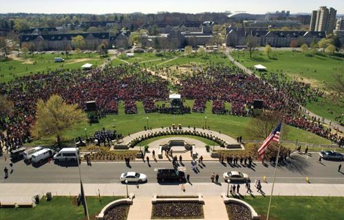 This photo provided by Virginia Tech shows mourners gathering Wednesday in front of the memorial for the victims of the April 16 shootings. Michael Kiernan, The Associated Press
