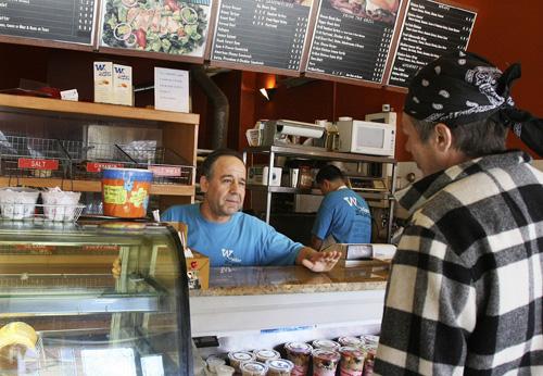 Owner Sam Iliewat talks with a customer at his Wonder Bagels store in Jersey City, N.J., on Monday. Food prices rose 4 percent nationally in 2007. Max Pasion, The Associated Press
