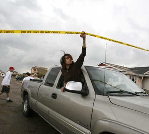 Motorists cross a police line set up in Windsor, Colo. after tornadoes touched down in northern Colorado and southern Wyoming on Thursday. Darin McGregor, The Associated Press
