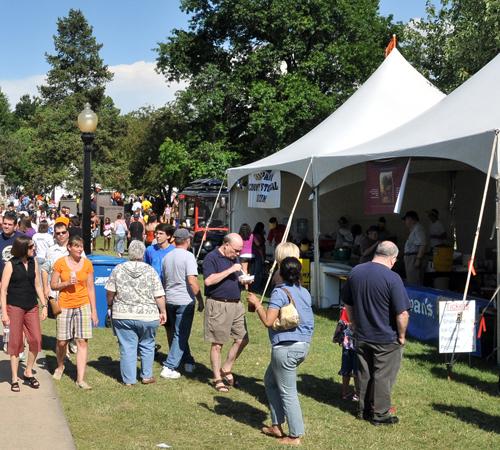 Crowds line the rows of food vendor tents during the Taste of Champaign-Urbana on Saturday at West Side Park. Wes Anderson
