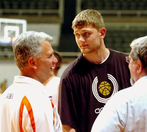 Tyler Griffey, a high school basketball player from Ballwin, Mo., and his father, Chris, talk with Illini basketball coach Bruce Weber at the Illinois basketball shootout Sunday. Griffey has verbally committed to Illinois for the class of 2009. Wes Anderson
