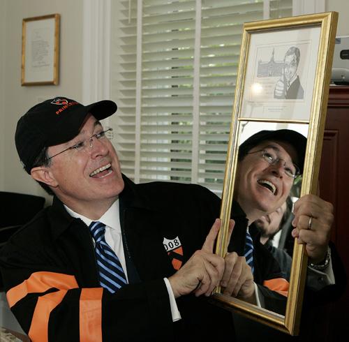 Stephen Colbert wears a Princeton cap and jacket as he holds up an award mounted on a mirror given to him after addressing 2,611 Princeton graduates-to-be assembled at Class Day, which is held each year the day before commencement, on Monday in Princeton, Susan Kantor
