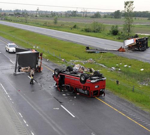 Debris from an overturned semi tractor trailer and a van are scattered across both lanes of Interstate 57 at Stuenkel Road in Will County, Illinois on Saturday evening. Police said one person was injured on Interstate 57, a 3-mile swath of which was close Mike Voss, The Kankakee Daily Journal
