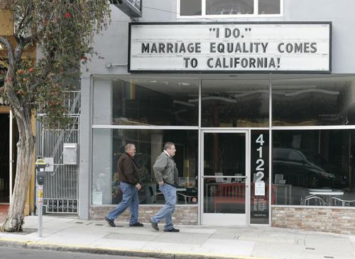 Pedestrians walk past a marquee supporting same sex marriage hanging above a Castro district strorefront in San Francisco on Monday. Local licensing clerks expanded their hours and religious conservatives warned of a backlash as California stood poised to Eric Risberg, The Associated Press
