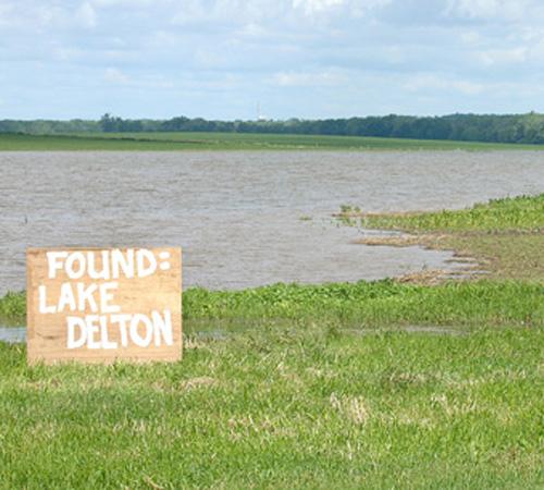 A homemade sign sits in front of submerged corn crops near U.S. 20 and South Springfield Road near Freeport, Ill. Monday. Heavy flooding in the Midwest has raised the price of crops, especially corn. Joe Tamborello The Journal-Standard for The Associated Press
