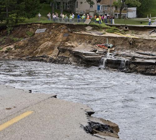 Flood waters wash out a roadway Monday in Lake Delton, Wis. A dam gave way under severe flooding Monday, unleashing a current that ripped homes off their foundations and down the Wisconsin River. Andy Manis, The Associated Press
