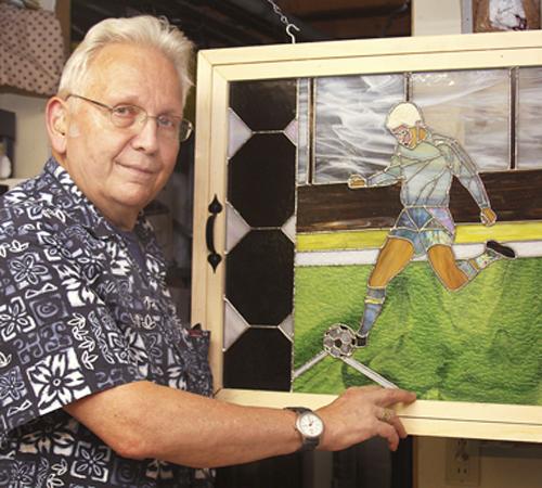 Ted Gross of Freeport, Ill., shows a stained glass art picture he made of his son Ryan playing soccer on June 11. Since retiring after 41 years, Gross has found a second career in stained glass. Jane Lethlean, The Associated Press

