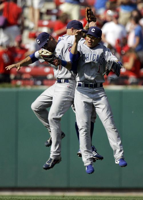 Chicago Cubs outfielders Mark DeRosa, left, Reed Johnson, center, and Kosuke Fukudome celebrate after defeating the St. Louis Cardinals 7-1 in a baseball game on Sunday in St. Louis. Jeff Roberson, The Associated Press
