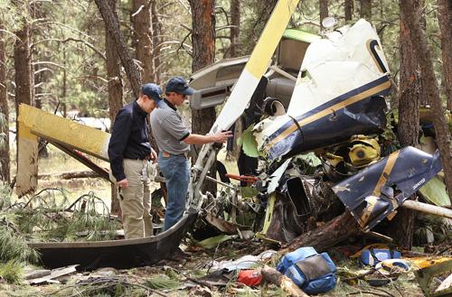 National Transportation Safety Board and Federal Aviation Administration workers survey the damage left by the crash of two medical helicopters Monday in Flagstaff, Ariz. A total of six persons died and one victim is still critical from the mid-air colli The Associated Press

