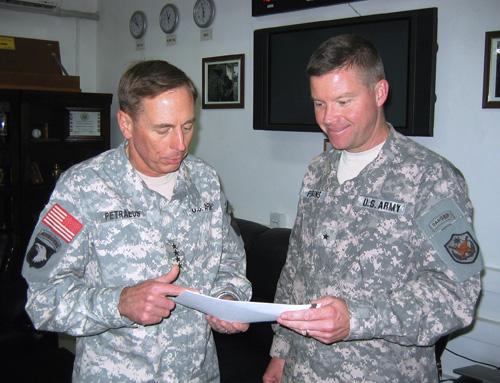 Gen. David Petraeus, left, the top U.S. commander in Iraq, talks with Brig. Gen. David Perkins, the top spokesman for the U.S., military command in Baghdad, in his office at the U.S. Embassy in Baghdad on Saturday. Al-Qaeda may be diverting fighters to th Robert Burns, The Associated Press
