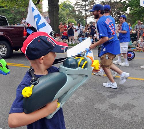 A young Cardinals fan leaves his mark on a group of Cubs fans marching in the Champaign-Urbana parade on July 4. Wes Anderson
