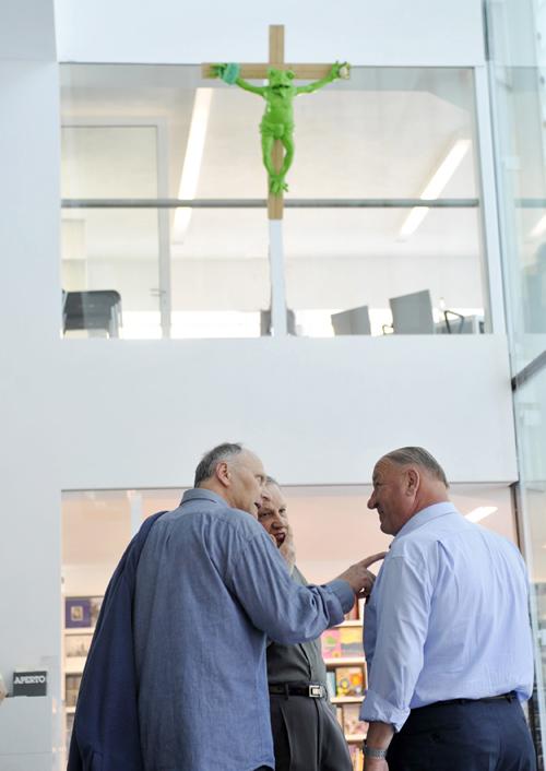 In this photo taken in June 2008 people talk under a sculpture portraying a green frog nailed to a cross, in the Museion" museum in Bolzano , northern Italy. Museum officials said Thursday Aug. 28, 2008 the sculpture that has angered Pope Benedict XVI and Othmar Seehauser, The Associated Press
