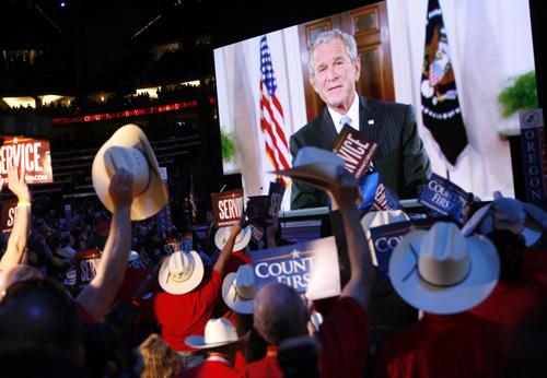 Texas delegates react as President Bush speaks via satellite at the Republican National Convention in St. Paul, Minn., on Tuesday. Charles Dharapak, The Associated Press
