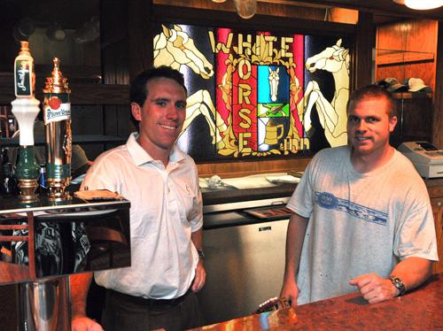 Tim Hoss Jr., left, and Blair Schober, two of the partners in the White Horse Inn reopening, stand behind the bar Tuesday afternoon. The bar is expecting to open on Friday at the earliest. Erica Magda
