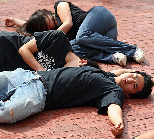 Student activists drop dead on the south side of the Union on Monday. They played dead for 10 minutes to raise awareness of North Korean issues and recruit supporters for the Liberty Live Tour on Wednesday. Emily Hopkins
