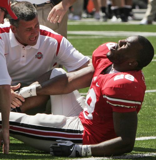 Ohio State running back Chris Wells reacts as trainers check on his injury during the third quarter of a college football game against Youngstown State on Saturday in Columbus, Ohio. Kiichiro Sato, The Associated Press
