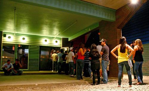 Students wait in line to enter FuBar, a Champaign bar on Green St., on Aug. 31. Many national university presidents are suggesti
