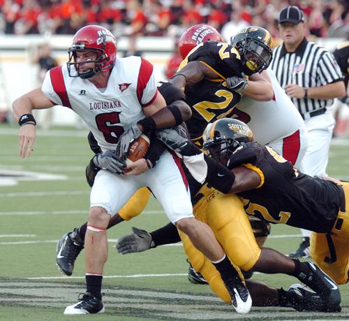 Louisiana-Lafayette quarterback Michael Desormeux (6) gets tackled by Southern Mississippi linebacker Korey Wiliams, behind, assisted by linebackers Gerald McRath (24) and Eric Phillips, lower right, in the first quarter of a college football game Aug. 30 Steve Coleman, The Associated Press
