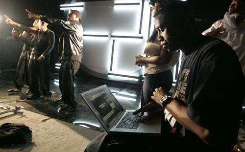 Record producer Chaka Zulu, right, looks through material from his artists to post on YouTube, while I20, second from left, Ludacris, left, and Rocko, film a video Sept. 2 in Atlanta. John Amis, The Associated Press
