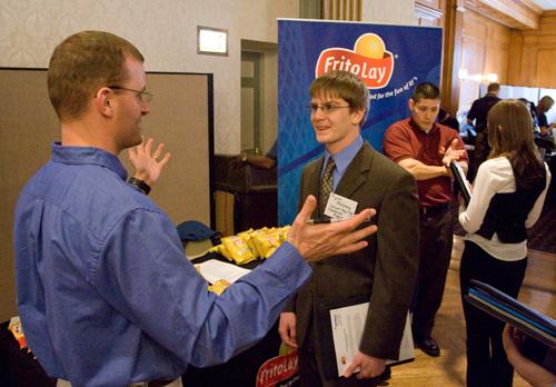Ryan Maloney, right, a senior in Engineering, speaks with a Frito Lay representative at the Engineering Employment Expo on Feb. 7. Ryan and hundreds of other engineering students met with hiring companies in the Illini Union. Erica Magda
