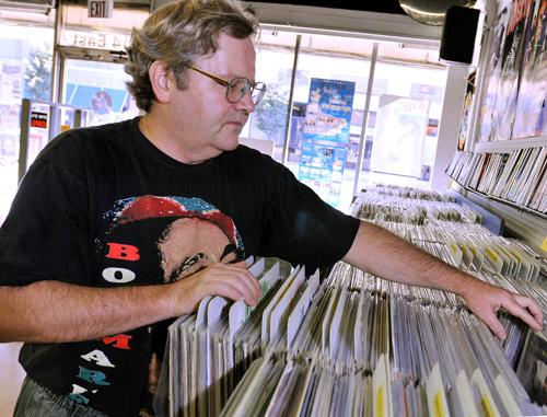 Record Swap owner Bob Diener looks through records in the shop Wednesday afternoon Erica Magda
