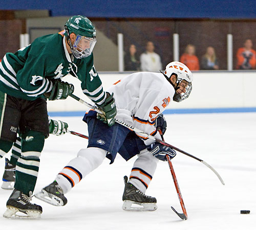 Junior JJ Heredia looks to pass the puck while being defended by a Michigan State opponent at the Ice Arena on Friday. The Illini won 2-1 against Michigan State on Friday and 8-0 on Saturday. Erica Magda
