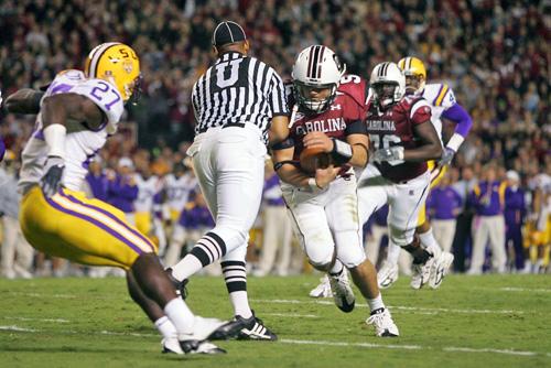 In this photo, umpire Wilbur Hackett Jr. collides with South Carolina quarterback Stephen Garcia (5) during the second quarter of an NCAA football game against LSU in Columbia, S.C., on Saturday. The collision has 14 different video versions and has been Gerry Melendez, The Associated Press

