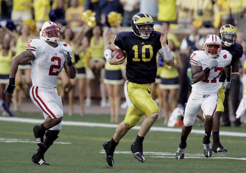 Michigan quarterback Steven Threet breaks downfield for a 58-yard run as Wisconsin linebacker Jonathan Casillas (2) and defensive back Allen Langford (17) try to catch him during the fourth quarter of the game in Ann Arbor, Mich., on Saturday. Carlos Osorio, The Associated Press

