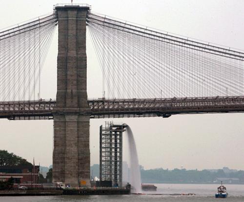 This June 26, 2008 file photo shows a man-made waterfall under the Brooklyn Bridge in New York. The The New York City Waterfalls was a windfall. Bebeto Matthew, The Associated Press
