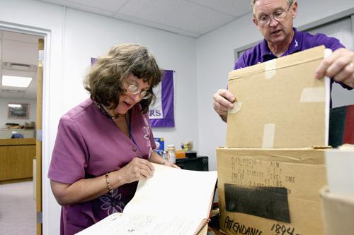 District 300 historian Patricia Menges and Hampshire Middle School Principal Jim Wallis go through some of the attendance and school board records dating back to the late 1800s on Aug. 13 in Hampshire, Ill. The school records were found in the safe of the Sandy Bressner, The Associated Press
