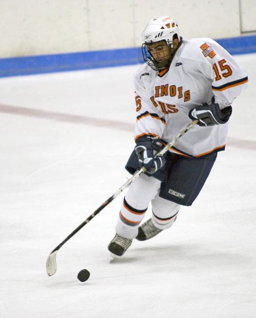 Illini hockey player Tony Razik crosses over the puck as he makes his way down the ice. The Illini swept Michigan State last weekend 2-1 and 8-0. weekend 2-1 and 8-0. Erica Magda
