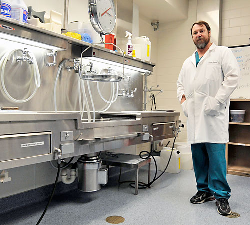 Charles Embrey, pathological assistant, stands in the morgue at Carle Hospital, 611 W. Park St, Urbana. Embrey started his career with the Armed Forces, and now works at Carle Clinic, performing autopsies and analyzing organs and tissues from patients aft Taylor Johnson
