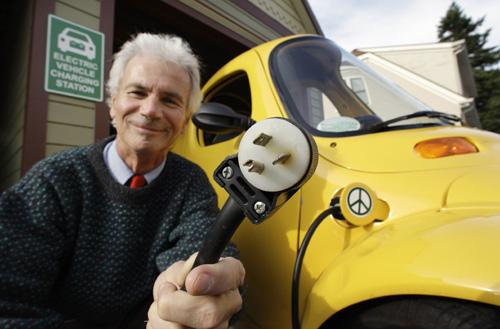 Steve Bernheim shows off his Corbin Sparrow fully electric auto in the driveway of his home in Edmonds, Wash., on Oct. 8. He has discovered several local charging stations to power his vehicle while on-the-go. Elaine Thompson, The Associated Press
