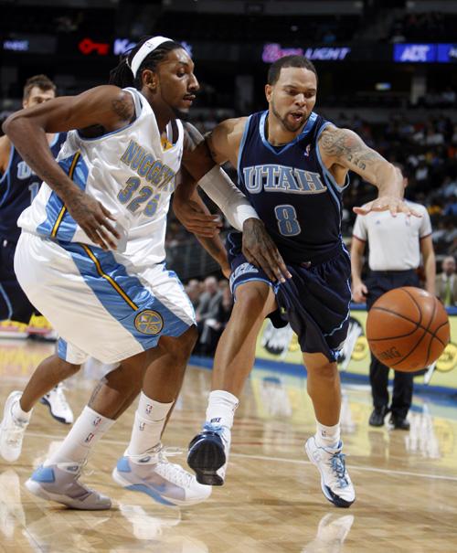 Utah Jazz guard Deron Williams, right, fights for a loose ball against Denver Nuggets forward Renaldo Balkman in a NBA exhibition game in Denver on Wednesday. Williams, a former U of I standout, and his team will compete against the Chicago Bulls on Frida David Zalubowski, The Associated Press
