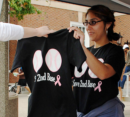 Jessica Remke, senior in LAS, receives a Save 2nd Base T-Shirt after donating to Colleges Against Cancer Monday on t

