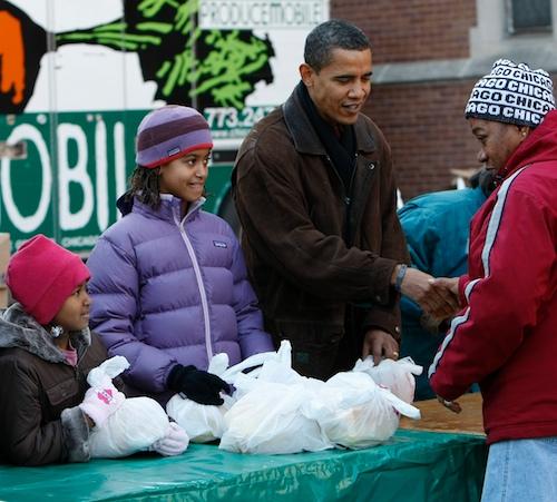 President-elect Barack Obama, second from right, his wife Michelle Obama, left, and daughters Sasha, 7, second from the left, and Malia, 10, second from the right, greet people at a food bank, sponsored by the Greater Chicago Food Depository, Wednesday, N Pablo Martinez Monsivais, The Associated Press
