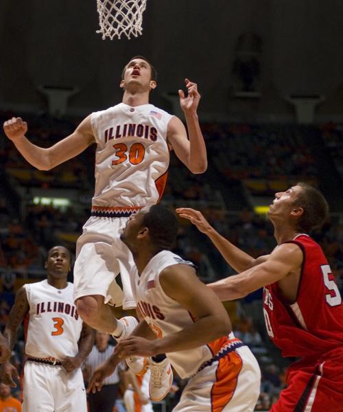 Bill Cole (30) jumps for a rebound during the exhibition game against Lewis University on Sunday. The Illini start the regular season Friday. Erica Magda

