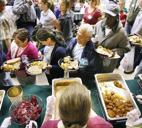 People line up for food during a Thanksgiving Day meal for the needy at the Salvation Army in Orlando, Fla. on Thursday, Nov. 27, 2008. Stephen M. Dowell, The Associated Pres
